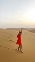 Girl among dunes in Rub al-Khali desert in United Arab Emirates video