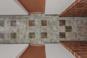 stone and ceramic floor tiles texture in corridor, view from above photo