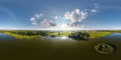 360 hdri panorama aerial view over lake with island in equirectangular seamless spherical projection with zenith and nadir,  ready for use as sky replacement in drone 360 panoramas or VR content photo