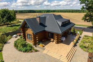 aerial panoramic view on wooden eco house or homestead in green village photo
