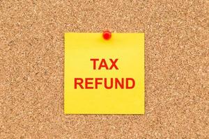 Yellow blank note and written TAX Refund for reminder. photo