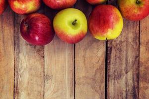 red apple on wood background texture with space for text photo