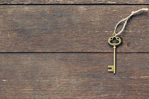 old key on wood background with copyspace. photo