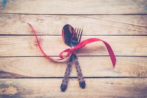 Valentines dinner on wooden background with space. Vintage style. photo