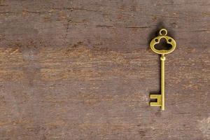 old key on wood background with space photo