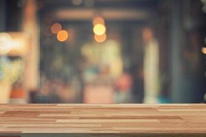 Empty wood table and Blurred background display at coffee shop with space for product. photo