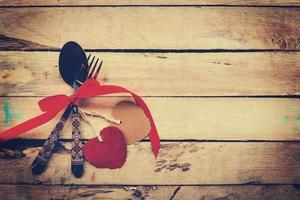 Valentines dinner on wooden background with space. Vintage style. photo