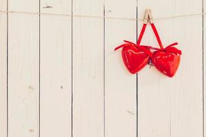 Two red heart hanging on white wood with space for Valentine and Wedding background. photo