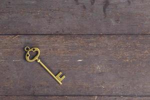 old key vintage on wooden background with space photo