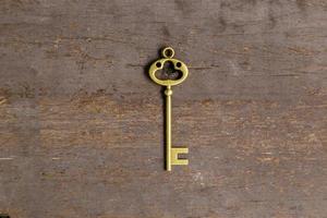 old key on wood background with space photo