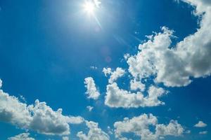 white clouds and blue sky with sunlight photo