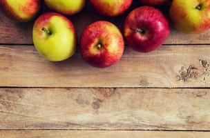 red apple on wood background texture with space for text photo