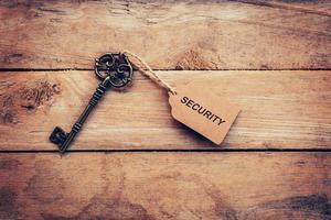 Business concept - Old key vintage on wood with tag security. photo