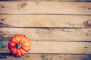 autumn background with pumpkin on wooden board with space, Vintage filter. photo