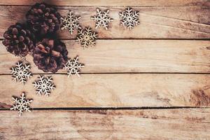 Pine cones and Snowflakes on wood  for christmas background with space. photo