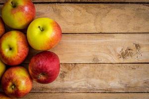 red apple on wood background texture with space for text photo