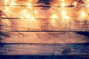 christmas light on wooden background with space photo