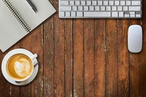 notepad, computer and coffee cup. View from above with copy space photo