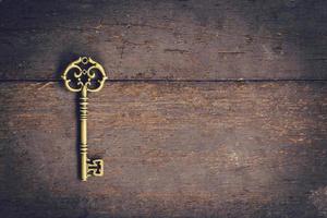 Old key vintage on wooden with space, Vintage filter. photo