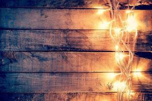 christmas light on wooden background with space photo