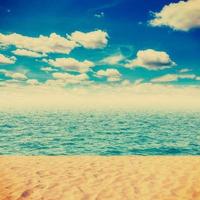 Vintage Beach and sand with white clouds blue sky photo