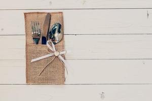 Christmas table place setting and silverware on wood with space and Table setting on wood background vintage. photo