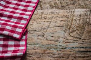 red fabric tablecloth textile on wooden background photo