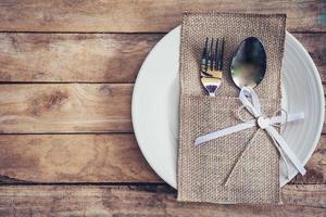 christmas table place setting and silverware on wood with space. photo