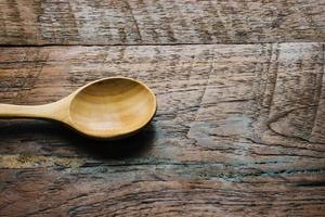 wood spoon on wooden table close up photo