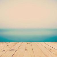 sea blurred and wood table for space with vintage tone. photo