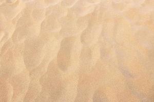 close up sand texture pattern background of a beach in the summer photo