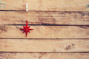 Ornamental red stars hanging on wooden for christmas background with space photo
