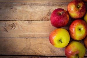 red apple on wood background texture with space for text photo