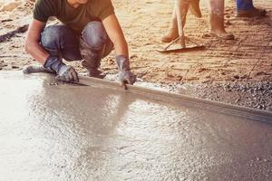 Plasterer screed concrete for floor in building photo