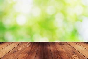 Wood table and bokeh abstract nature green background photo