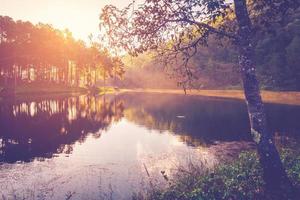 Pond water and sunrise with vintage effect. photo