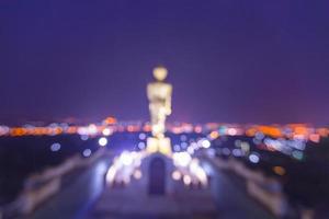 Blurred statue of buddha and city at Wat Phra That Kao Noi Temple Nan, THAILAND. photo