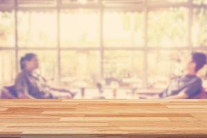 Empty wood table and Blurred background display at coffee shop with space for product. photo