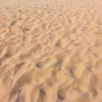 footmarks on sand and sand texture and background photo