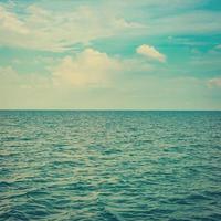 Green sea with waves and clear blue sky vintage photo