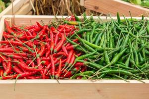 red pepper and green pepper on shelf in market. photo