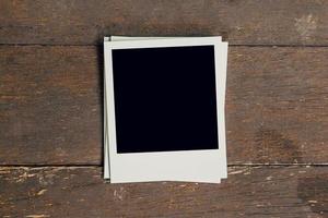 Vintage photo frame blank on old wood background with space