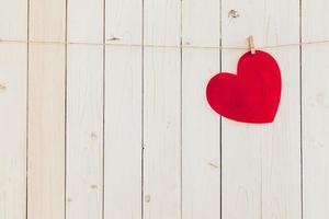 Blank red heart hanging on white wood with space for Valentine and Wedding background. photo