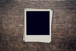 Vintage blank photo frame on wood background with space