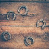 old horse shoe on wood background photo