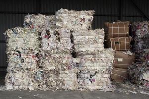 Wastepaper compact texture pile for recycling on sorting plant. Technology of reuse materials. Stack of shredded paper. Save the planet ecology concept. Industry of reduced pollution factory. Close-up photo