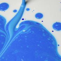 Liquid paper blue and color variation paint background. photo