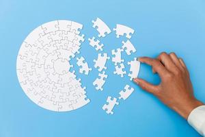Pieces of jigsaw puzzle in man's hands, Business solutions, success and strategy concept. photo