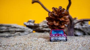 toy car hauling pinecones on an orange background photo