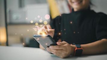 Shopping online payment concept. Woman hand using smart phone with cart delivery icon, banking and online shopping via banking mobile app, E-transaction and financial technology. photo